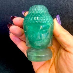 A set of two Buddha. The larger one is fluorite the baby one is adventurine.